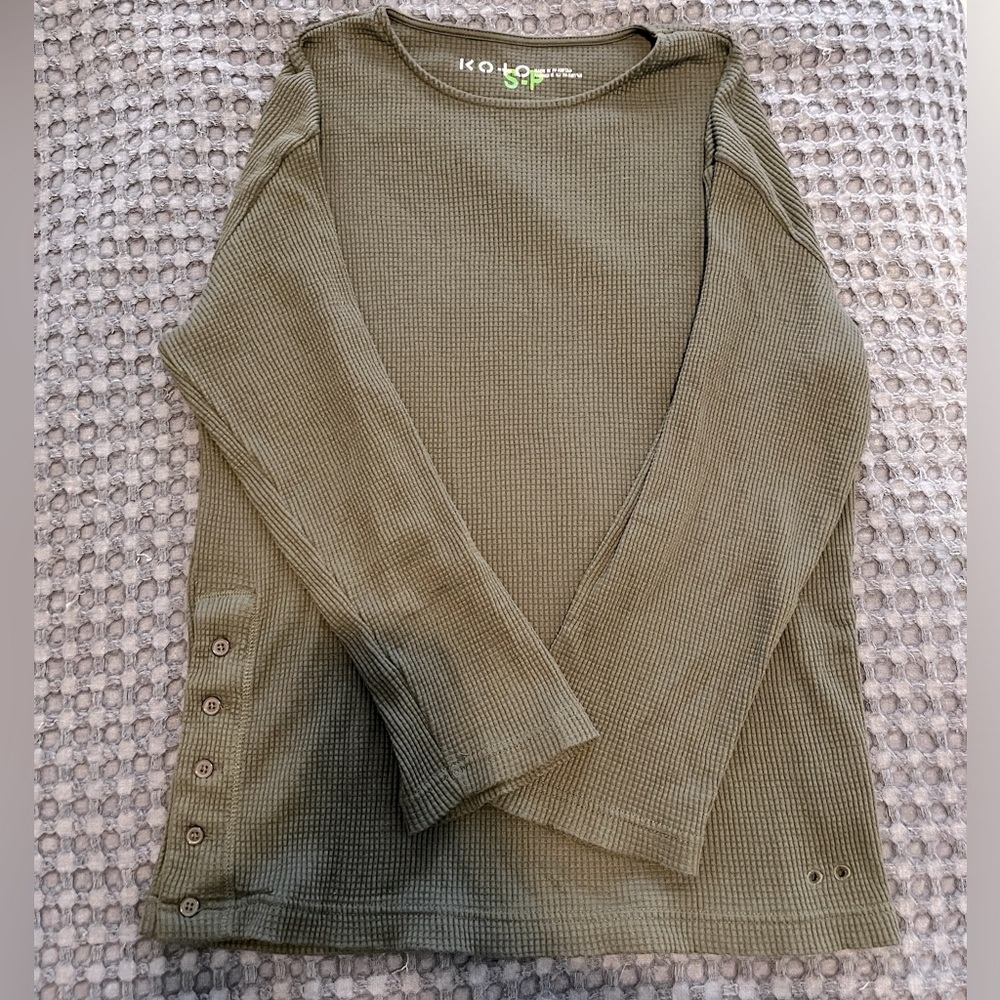 Women’s small oversized waffle long sleeve with side buttons and grommet detail.